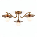 Three-light brass ceiling fixture with perforated shades and globes